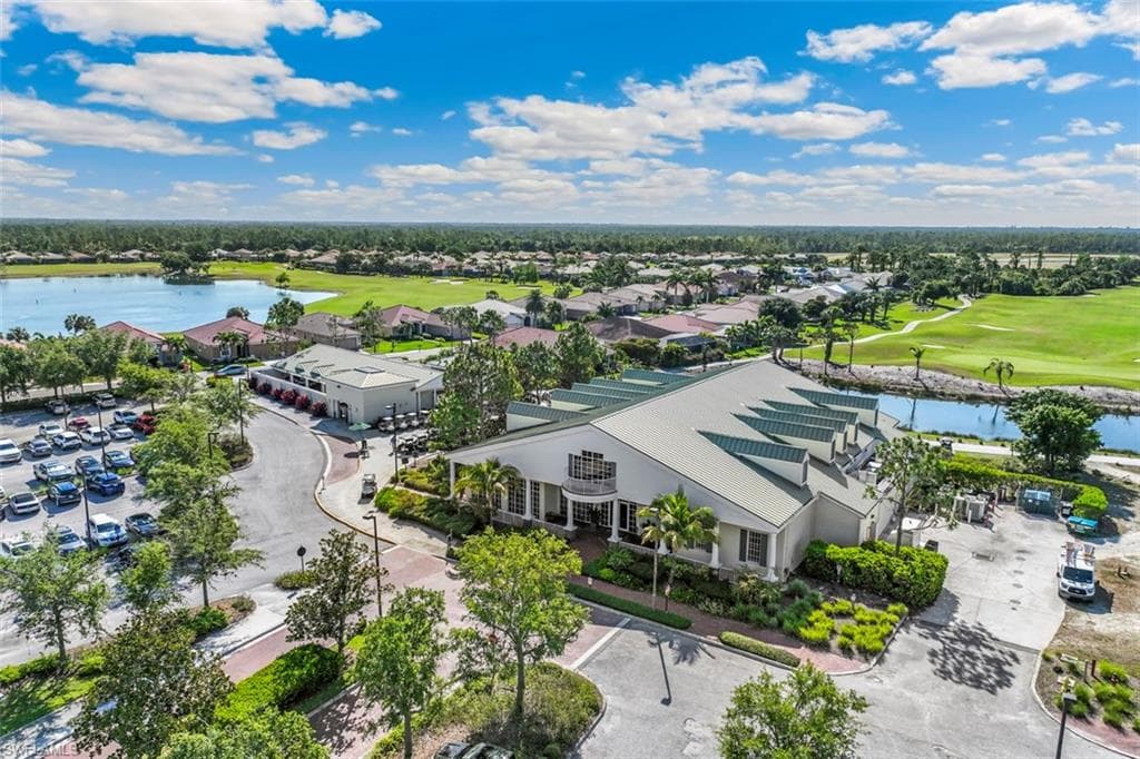 This aerial view showcases the property's advantageous position within a community featuring a golf course and a large body of water
