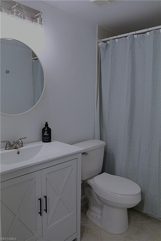 Full bathroom with vanity, a shower with curtain, and light tile patterned flooring