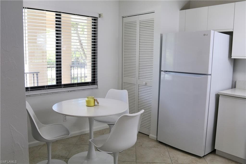 Dining room featuring light tile patterned floors and baseboards