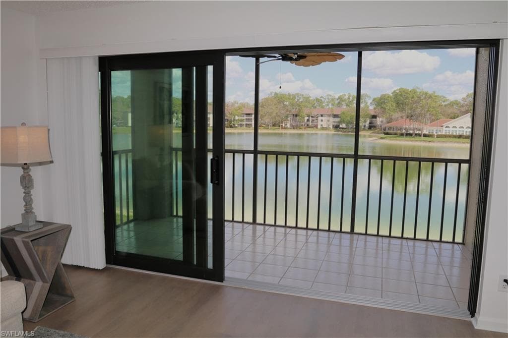 Doorway to outside featuring wood finished floors and a water view