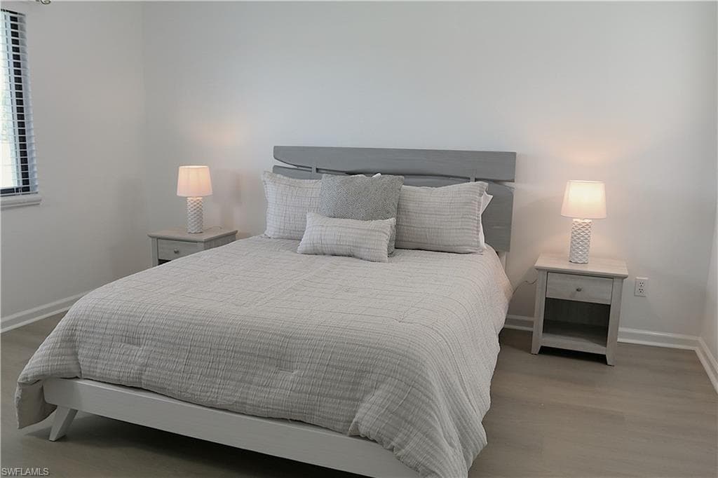 Bedroom featuring baseboards and light wood-style floors