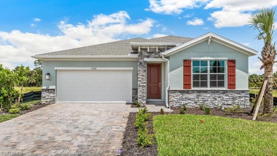 Model Home - Contemporary stucco exterior with stone veneer accents, a paver driveway, a single-car garage, a red entry door, and decorative red window shutters
