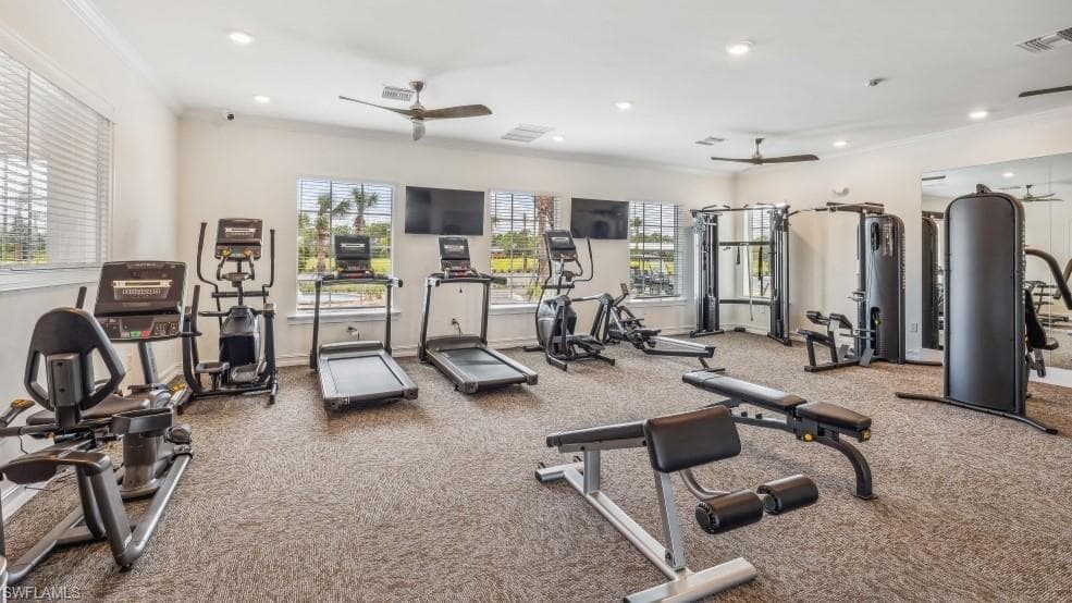The property features a well-equipped fitness center with cardio machines, weight training equipment, and reflective wall panels