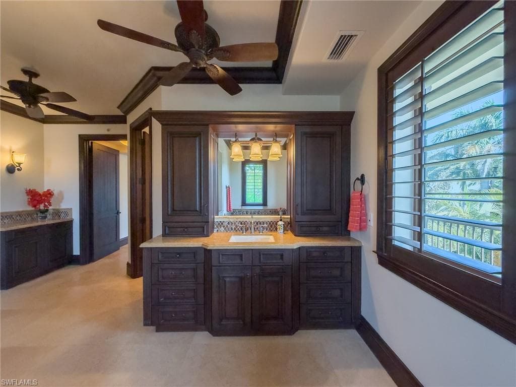 Bathroom featuring a ceiling fan and vanity