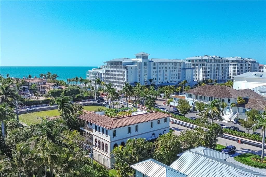 Drone / aerial view of a large body of water and apartment complex