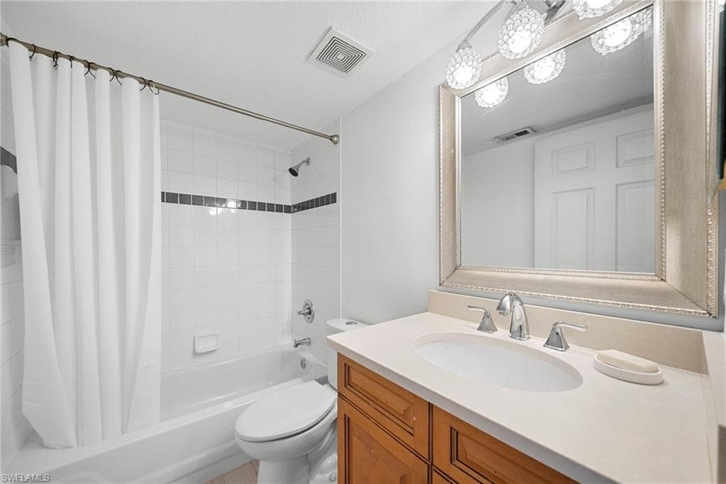 Bathroom with vanity and shower / tub combo with curtain