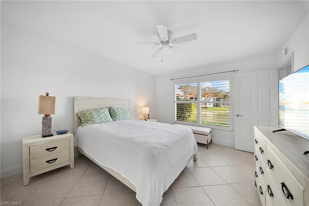 Bedroom featuring light tile patterned flooring and a ceiling fan