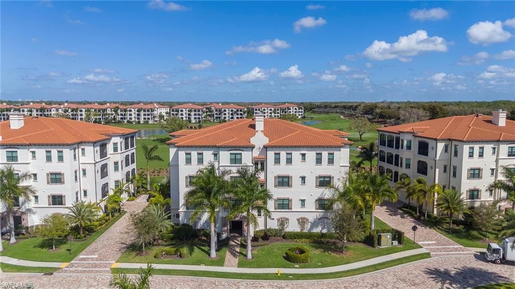 Aerial view of apartment complex and a large body of water