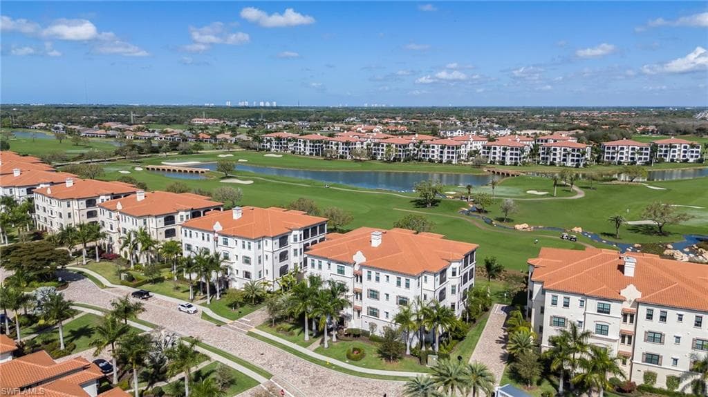 Drone / aerial view of apartment complex and a local golf course