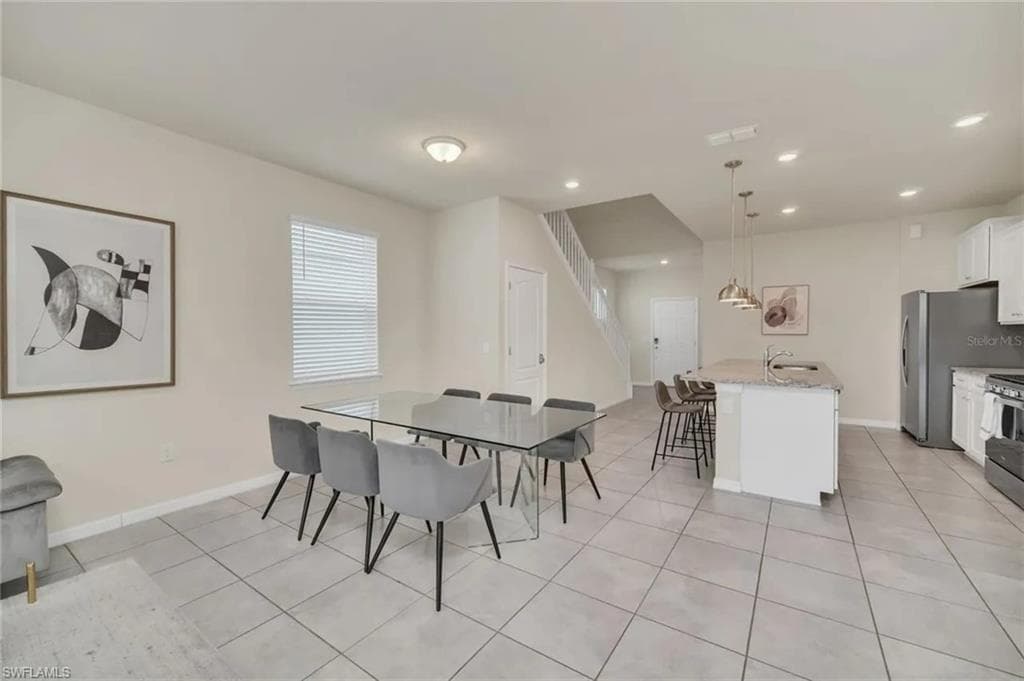 Dining area featuring baseboards and light tile patterned floors