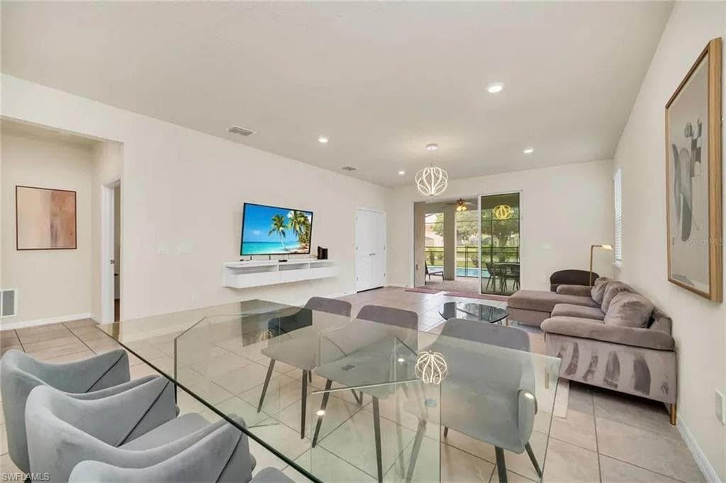 Living area featuring light tile patterned floors and recessed lighting