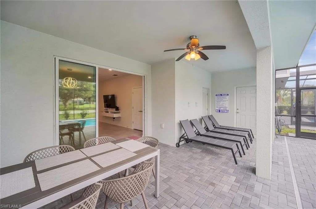 View of patio / terrace featuring outdoor dining area, a ceiling fan, and a lanai