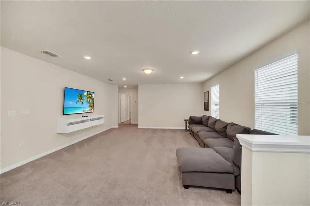Living room featuring recessed lighting and light carpet