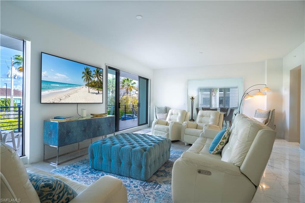 Bright living area featuring polished tile flooring