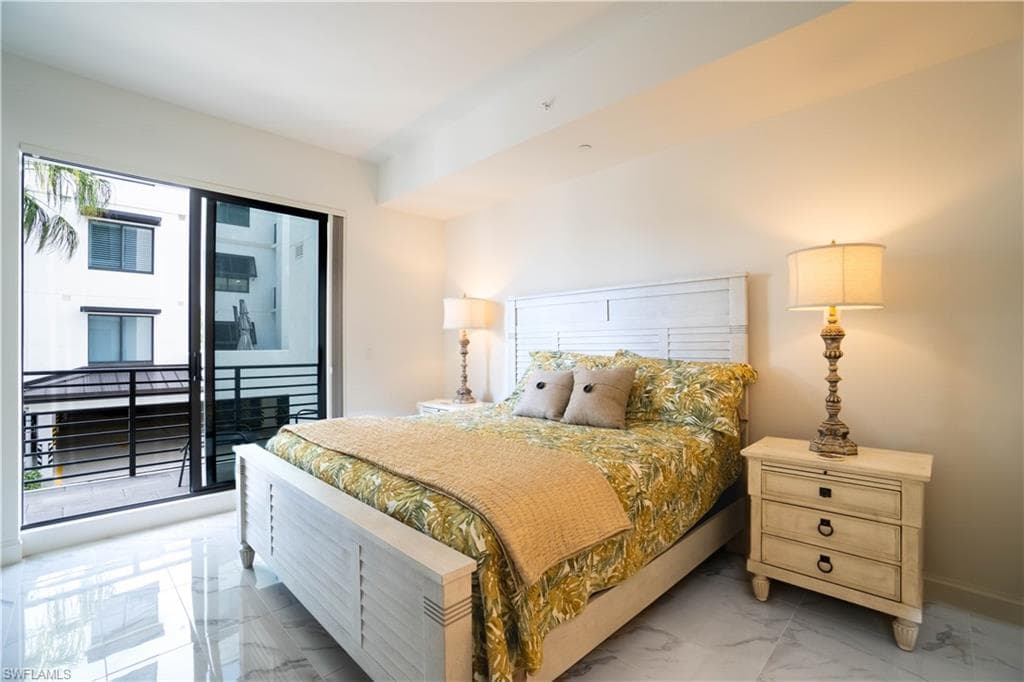 Bedroom featuring light marble finish floors