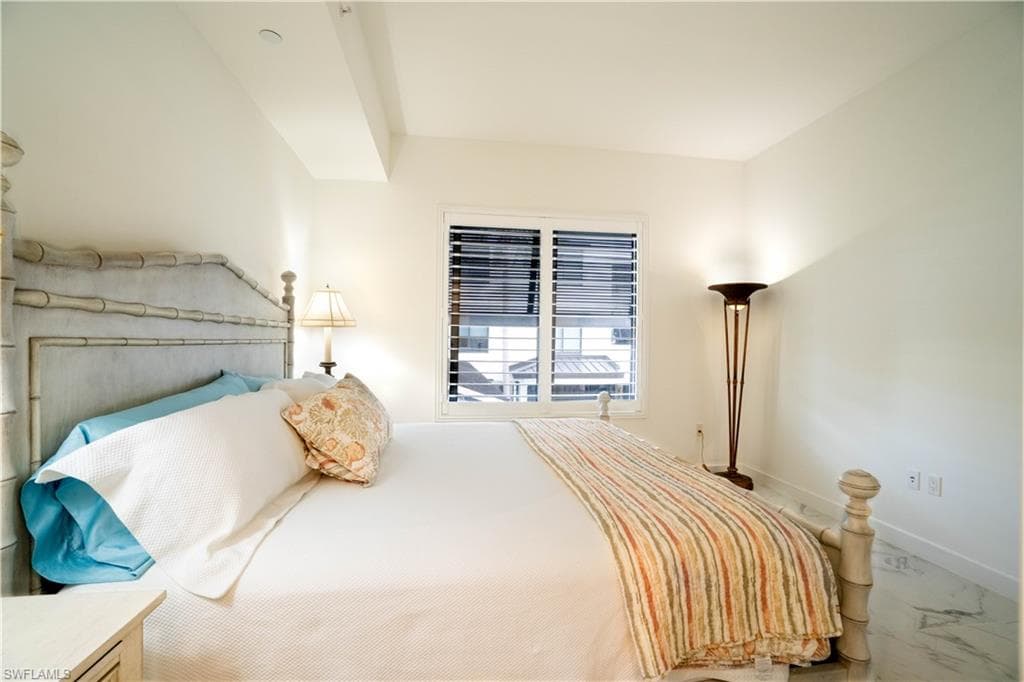 Bedroom with baseboards and marble finish flooring