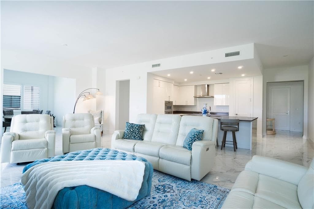 Open-concept living area with polished tile flooring