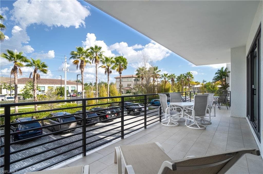 Balcony with a residential view and outdoor dining area