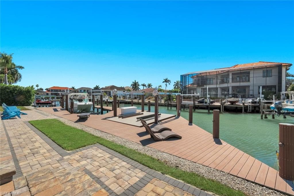Dock area with a water view and boat lift