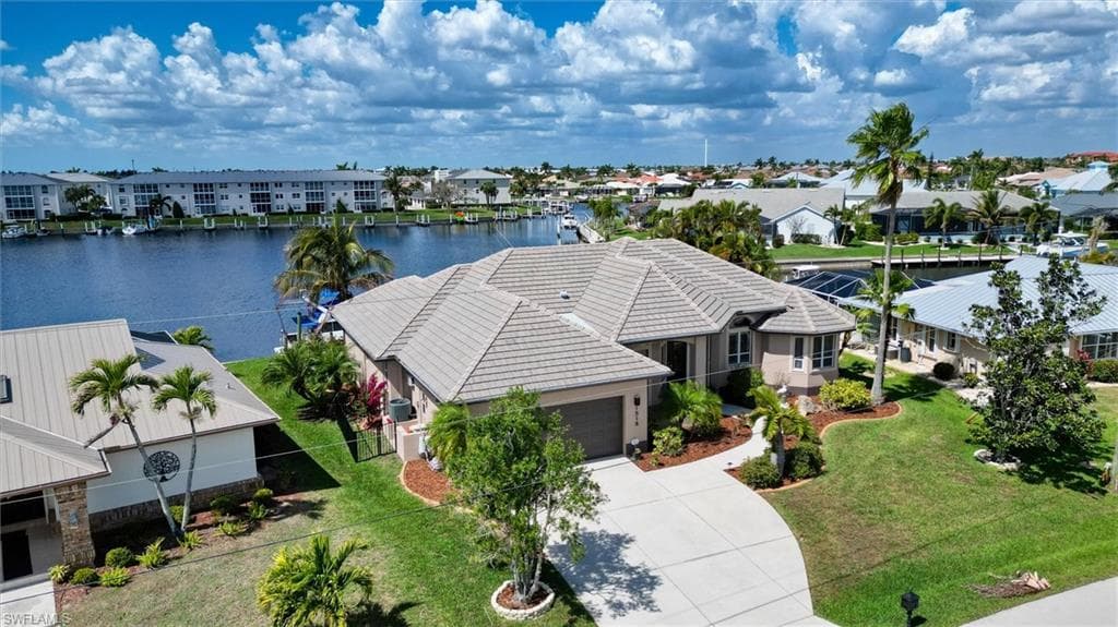 Aerial view of residential area featuring a nearby body of water
