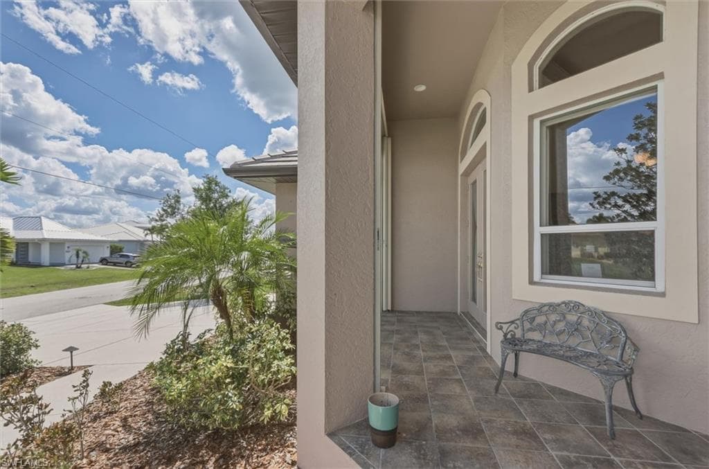 Doorway to property with stucco siding