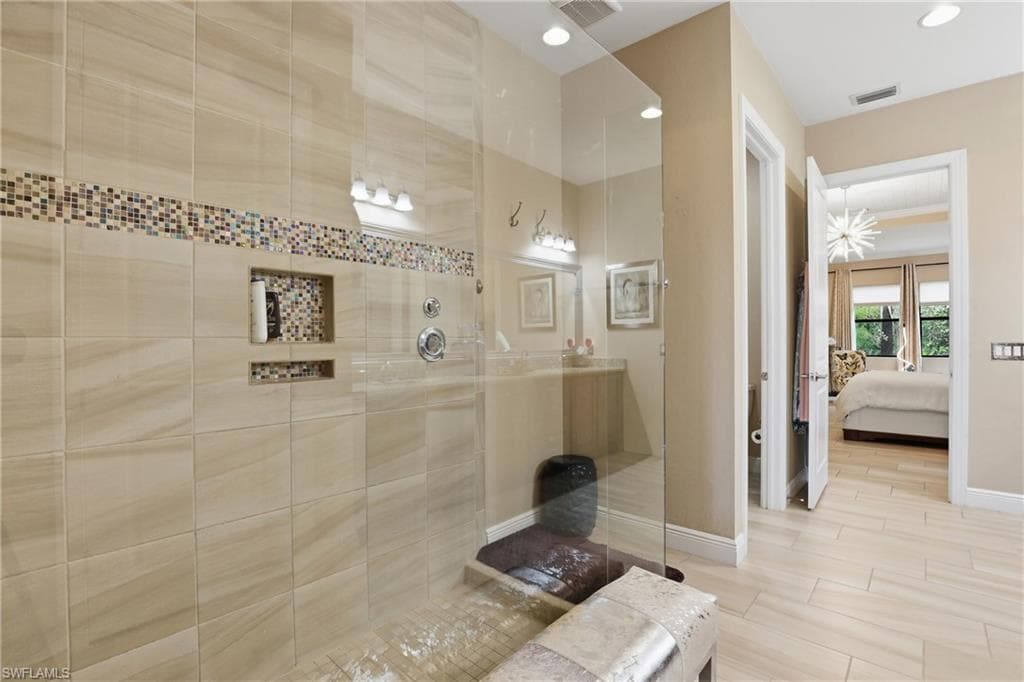 Full bath featuring connected bathroom, a walk in shower, and recessed lighting