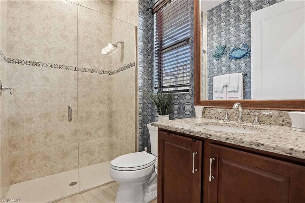 Full bath with vanity and a shower stall