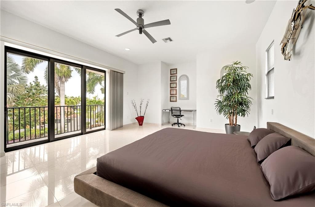 Bedroom with ceiling fan, access to exterior, and a desk