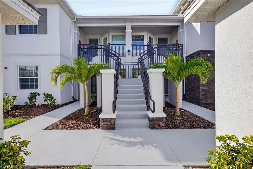 Entrance to property with stucco siding