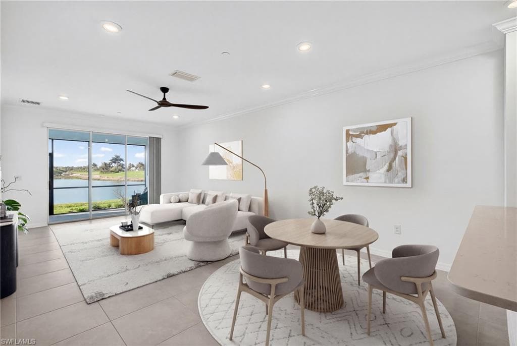 Dining area featuring recessed lighting, crown molding, a water view, a ceiling fan, and light tile patterned floors