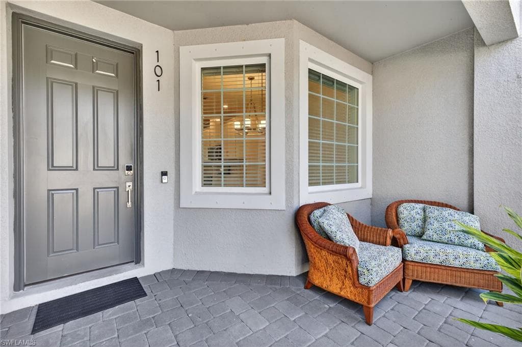 Doorway to property with stucco siding