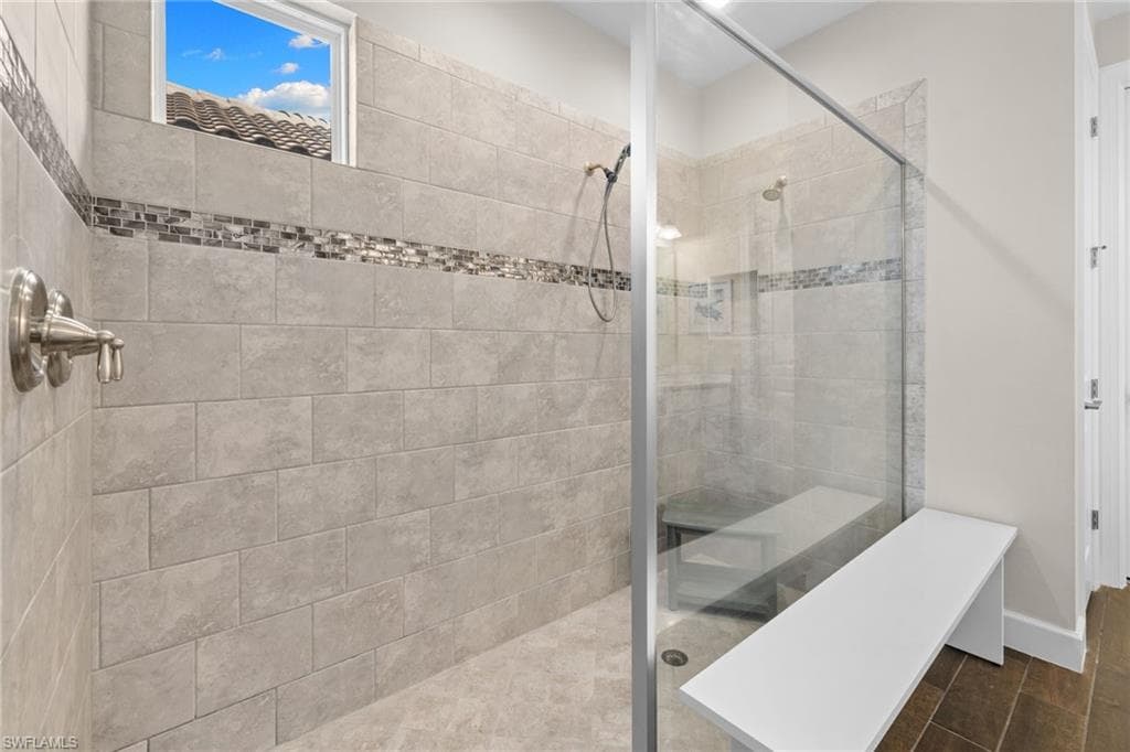 Full bath featuring walk in shower and wood finish floors