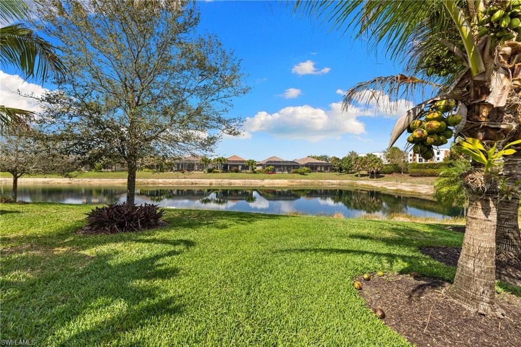 View of green lawn featuring a water view
