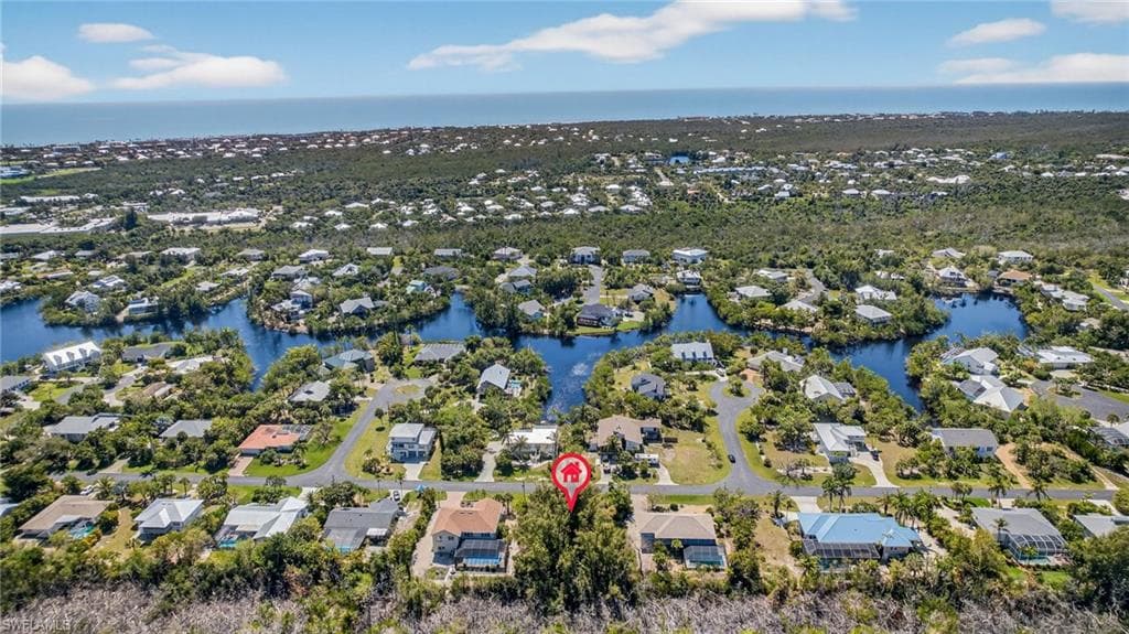 Aerial perspective of suburban area featuring a large body of water