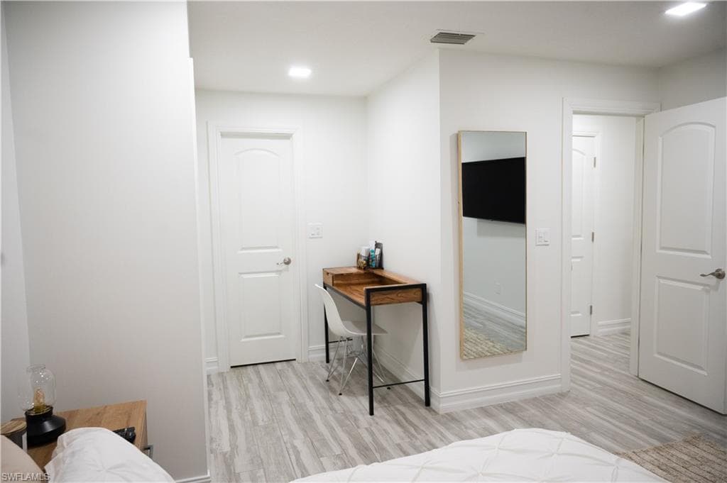 Bedroom featuring light wood-style flooring and recessed lighting
