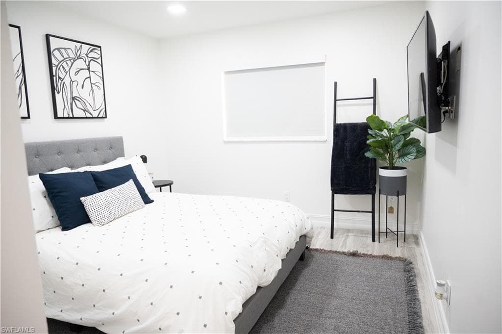 Bedroom featuring wood finished floors and recessed lighting