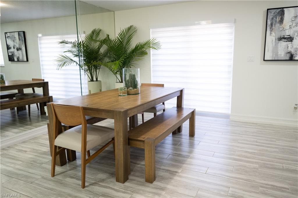 Dining space featuring light wood-style floors and baseboards