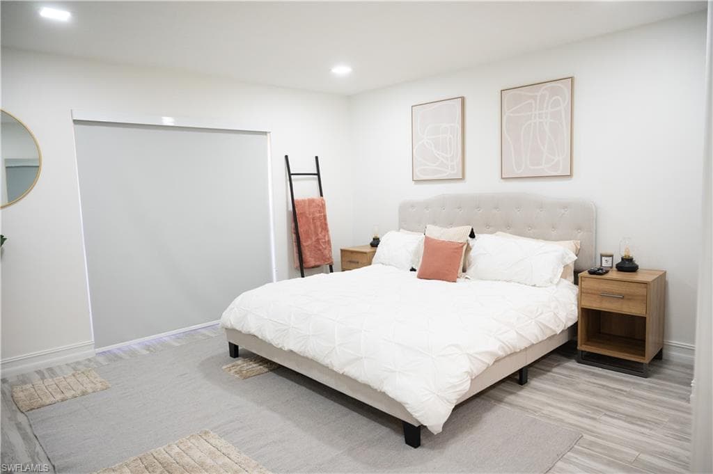 Bedroom with light wood-style flooring and recessed lighting