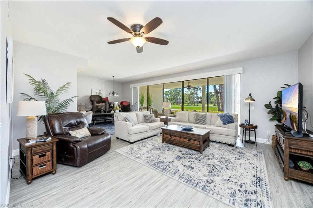 Living area featuring a ceiling fan and light wood-style floors