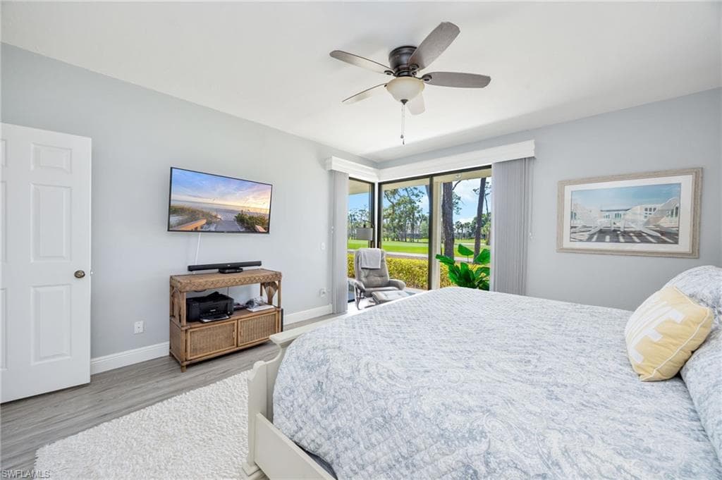 Bedroom featuring access to exterior, ceiling fan, and wood finished floors
