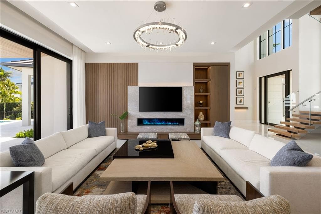 Living area with a fireplace, hanging lights, and built in features