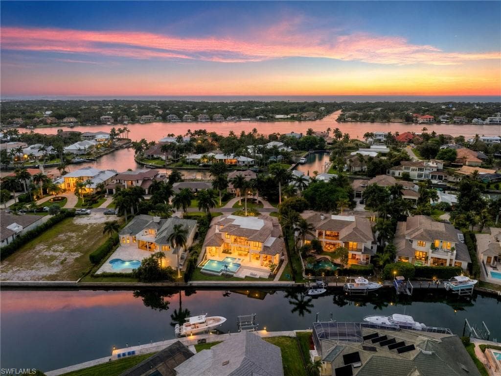 Aerial view at dusk of a water view and a residential view