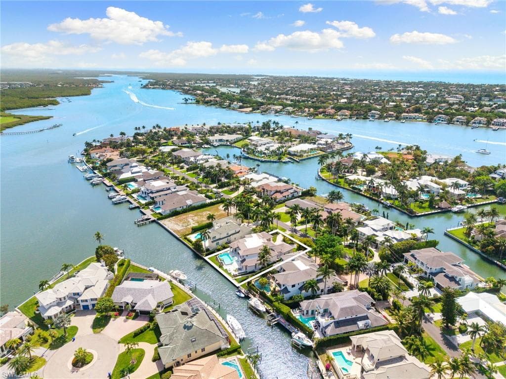 Aerial perspective of suburban area with a nearby body of water