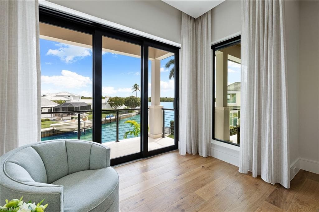 Sitting room featuring a water view and light wood-style flooring