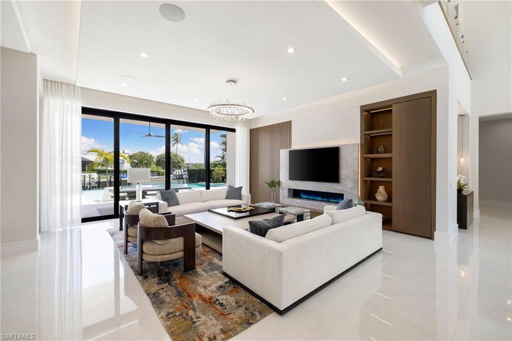 Living area featuring hanging lights and built in shelves