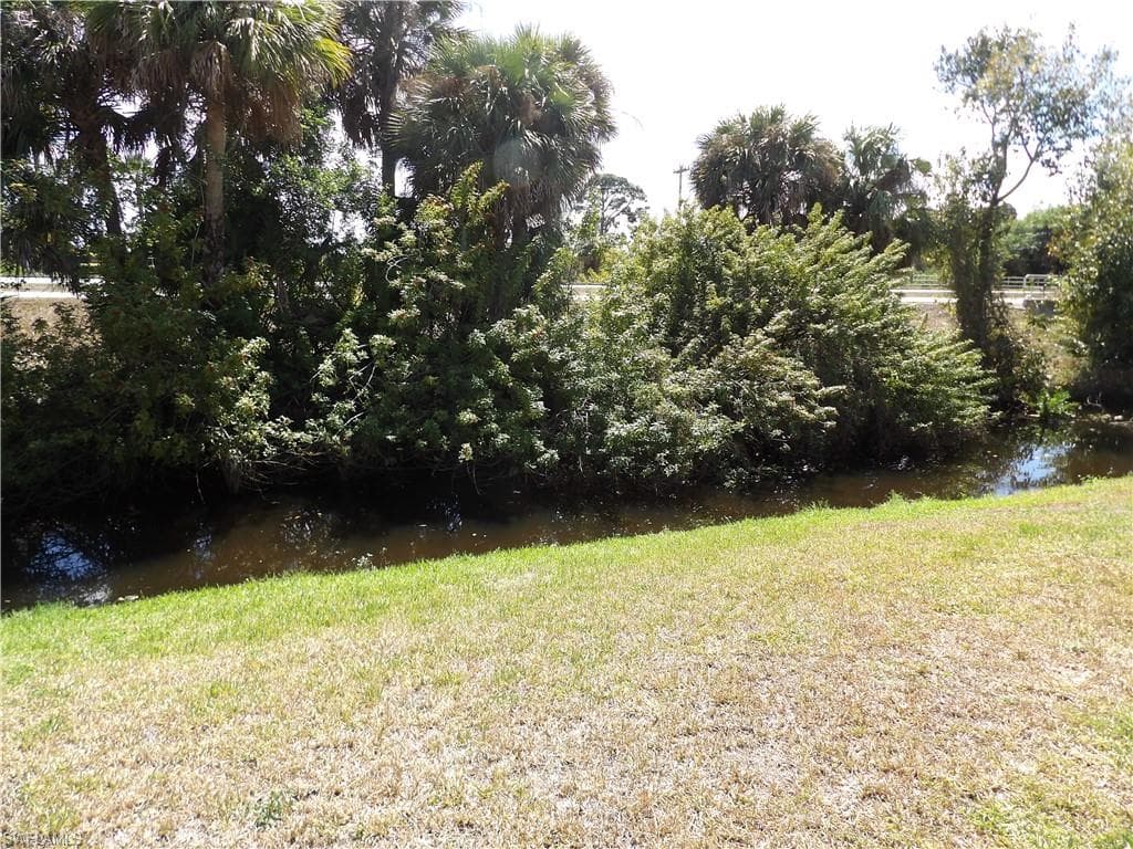 View of green lawn with a water view