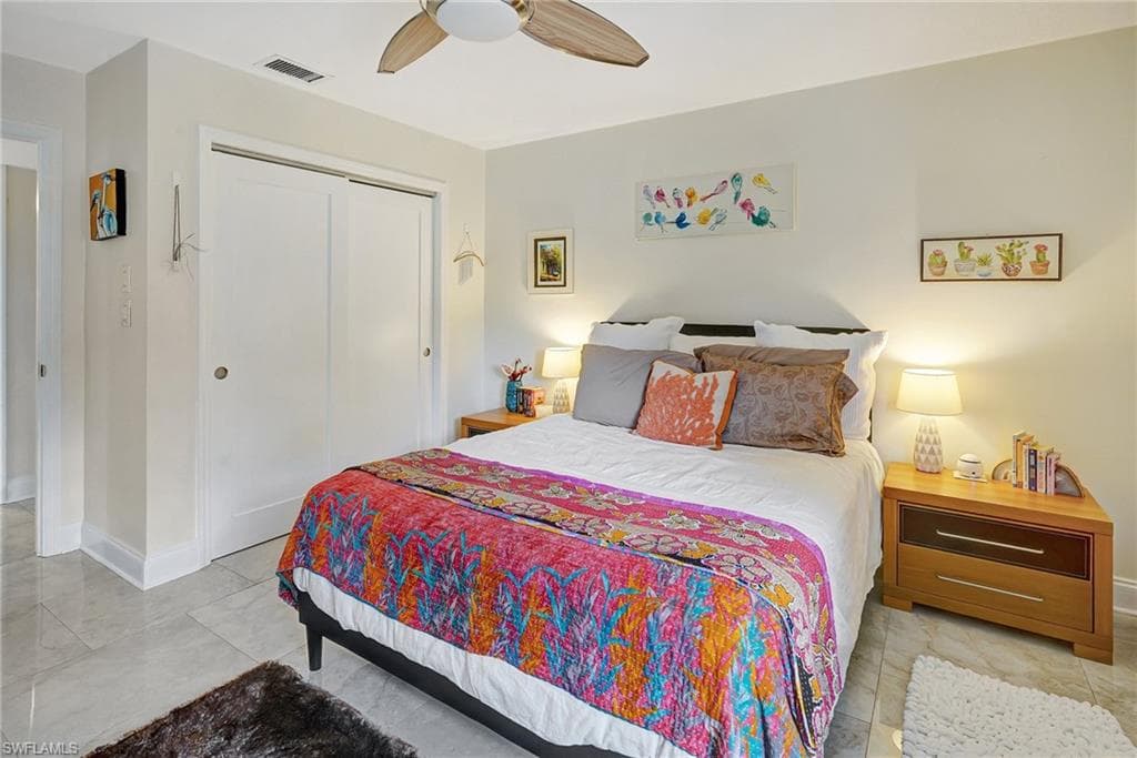Bedroom with baseboards, a closet, and ceiling fan