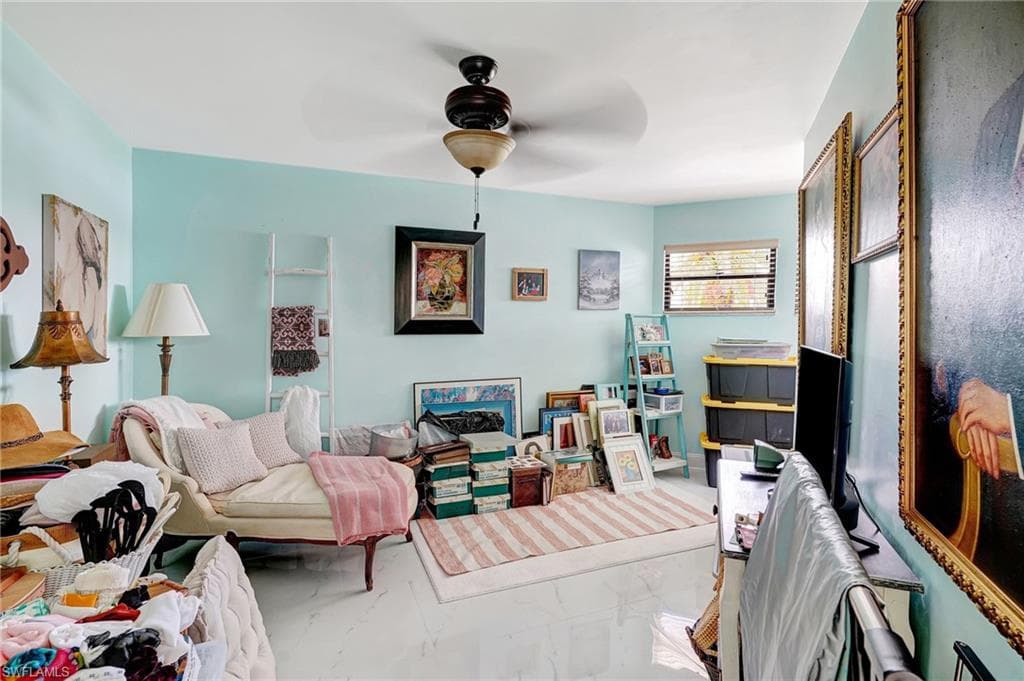 Bonus room featuring marble finish floor and ceiling fan