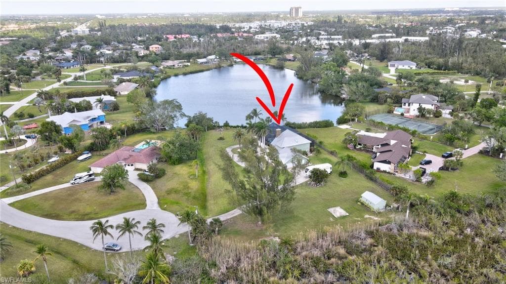 Aerial view featuring a residential view and a water view