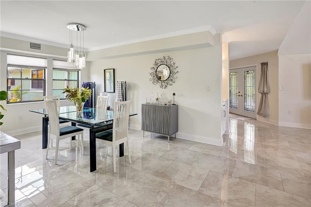 Dining room with marble finish floor, a healthy amount of sunlight
